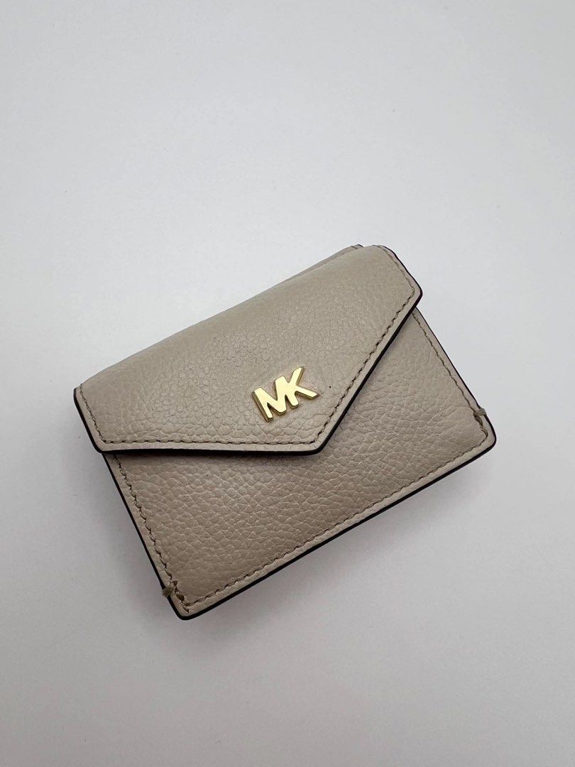 Authentic MK Compact trifold wallet in ivory color. (Category: Wallets & Card holders) located in Cagayan de Oro. Submitted by borse_de_amore (Listing ID 1466424628, Image 1). Description: Authentic MK Compact trifold wallet in ivory color. Rank A pa only flaws is pressmarks. Very cute can fit in small bags 🏷️1,580.
