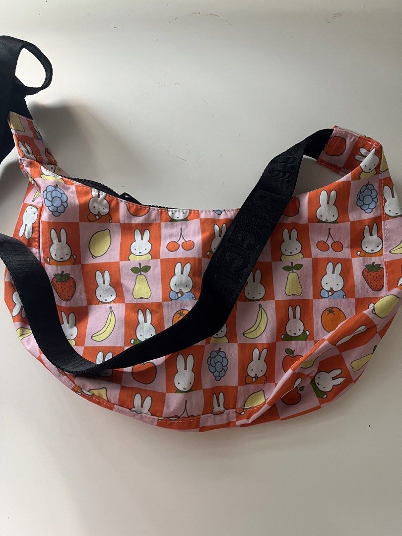 Baggu x Miffy Medium Nylon Crescent Bag Checkered Fruit (Category: Shoulder Bags) located in Cainta. Submitted by nitro_ups (Listing ID 1466411636, Image 1). Description: - Unused & Authentic Baggu Medium Nylon Crescent Bag - Rare Checkered Fruit Miffy print (Pink & Orange with Miffy and assorted fruits) - Brand new with tag attached - Made of durable, heavyweight recycled nylon - Comfortable black strap with Baggu branding .