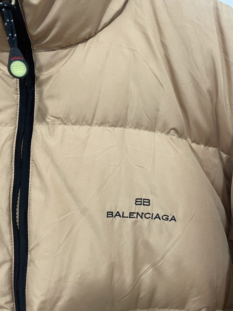Balenciaga Puffer Jacket Beige (Category: Coats, Jackets and Outerwear) located in Manila. Submitted by oenthrift.2026 (Listing ID 1466505699, Image 2). Description: Balenciaga puffer jacket in khaki beige. fits oversized. Black contrast collar and zipper track. Down and feather filling inside, super warm for cold weather. Front zip closure with custom branded zipper pull. Embroidered BB logo on the chest. Style number BJ93345-49 printed on inter