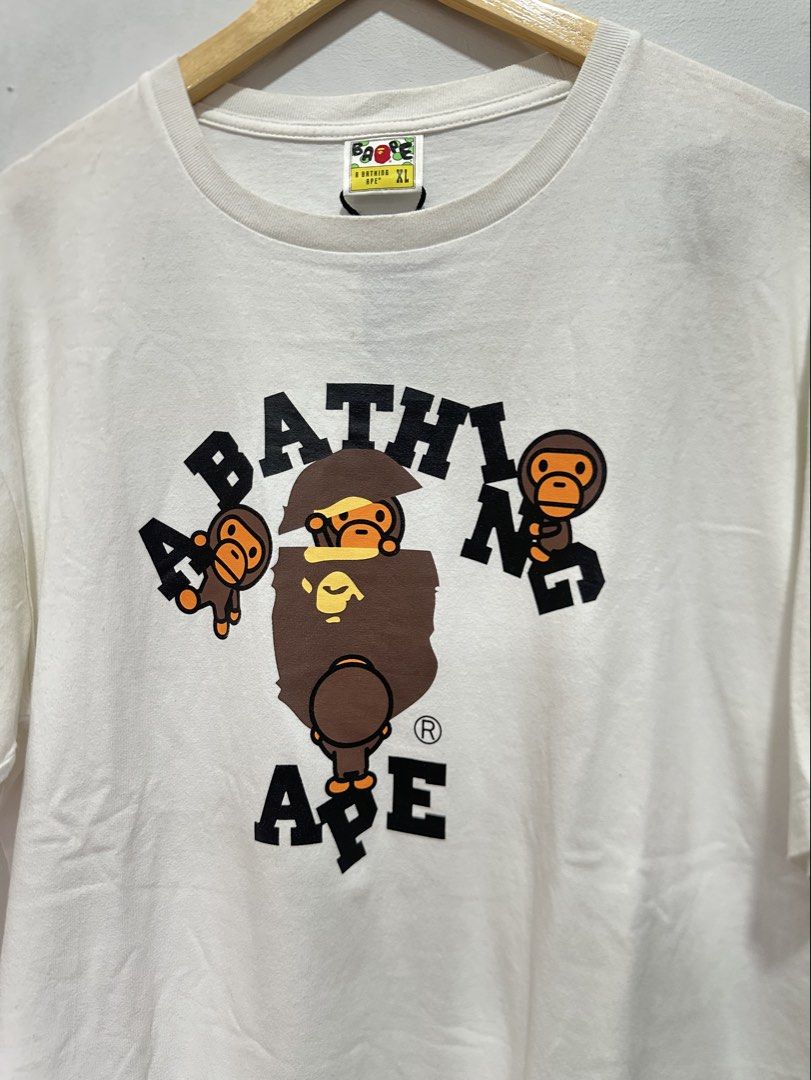 BAPE Baby Milo A Bathing Ape Graphic Tee White (Authentic) (Category: Tshirts & Polo Shirts ) located in Manila. Submitted by ylsrarities (Listing ID 1466545227, Image 2). Description: Details: • Brand: A Bathing Ape / BAPE • Size: XL • Color: White • Graphic: Baby Milo / Bathing Ape • Measurements: 22Wx29L • NOWHERE CO., LTD. neck label • Original BAPE sleeve Ape tag Condition: 9/10 Good condition with normal signs of age and wear. Please review