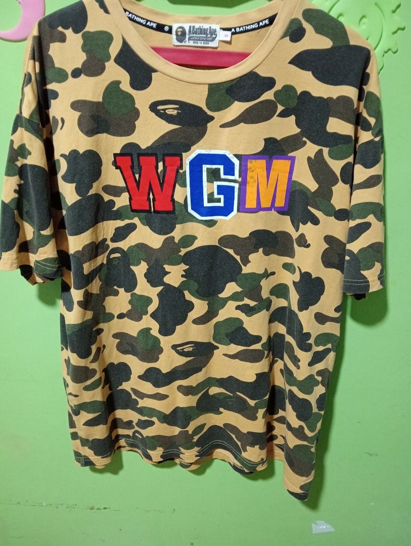 BAPE Yellow Camo WGM Shark Tee (Category: Tshirts & Polo Shirts ) located in Caloocan City. Submitted by yazzielux (Listing ID 1466348307, Image 3). Description: - Brand: BAPE (A Bathing Ape) - Design: Yellow camo with signature back shark face graphic and large WGM chest lettering - Fit: Standard streetwear fit - Details: Short sleeves, crew neck - Authenticity: Includes inner neck tags and wash care labels - Condition: Brand new / Excellent qua