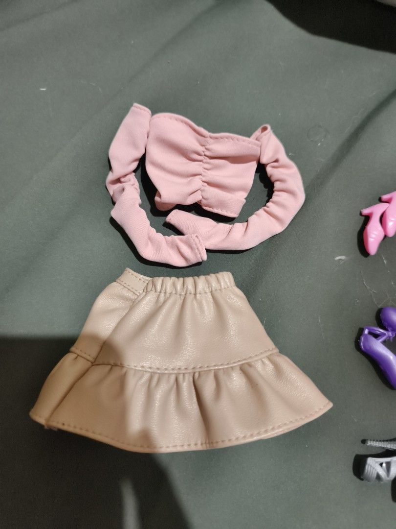 Barbie Doll Clothes, Shoes and Stands Bundle (Category: Kids Toys) located in Cavite. Submitted by ybk_88 (Listing ID 1466560587, Image 2). Description: - Massive doll fashion lot, perfect for expanding any doll wardrobe - Includes 5 dresses, a pink top, and a beige skirt - Multiple pairs of trendy heels and sandals - Assorted headbands for styling - 1 authentic Shadow High branded hanger - 2 clear doll stands with black and beige bases - Great m