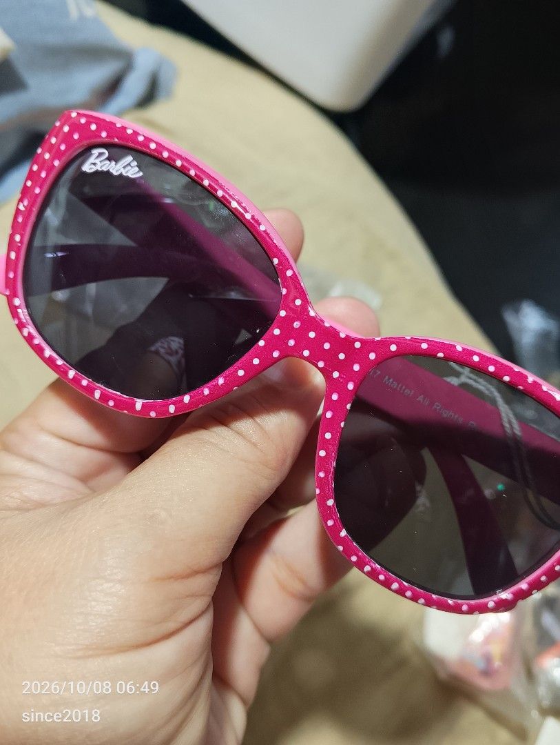 Barbie Pink Polka Dot Sunglasses Mattel 2017 (Category: Sunglasses & Eyewear) located in Quezon City. Submitted by sellingwithlove2018 (Listing ID 1466561920, Image 2). Description: - Authentic Barbie collectible sunglasses - Bright pink frames with playful white polka dots - Dark tinted lenses with white Barbie logo on the corner - Inner temples feature Mattel 2017 copyright and style code 2331-03 - Perfect fun accessory for fans and collectors 
