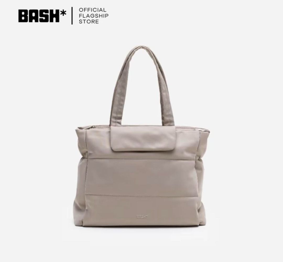 BASH Official Tote Bag (Category: Tote Bags) located in Manila. Submitted by btrzsvll (Listing ID 1466356386, Image 1). Description: - Brand: BASH official flagship store - Color: Neutral beige - Style: Soft puffer construction with clean solid finish - Features: Dual shoulder straps, front flap pocket, and subtle embossed branding near the base - Interior: Spacious main compartment for your daily essentials.