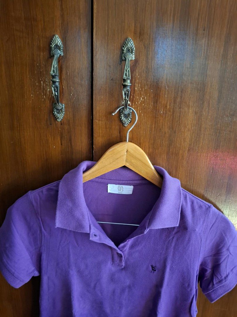 Bayo Purple Polo Shirt (Category: Tshirts & Polo Shirts ) located in Manila. Submitted by bunbun__ (Listing ID 1466414261, Image 1). Description: - Brand: Bayo - Color: Purple - Material: Comfortable cotton blend - Fit: Standard fit - Details: Classic collar, front button placket, short sleeves, ribbed cuffs and collar, small embroidered chest detail - Condition: Excellent, easy to style for casual days.