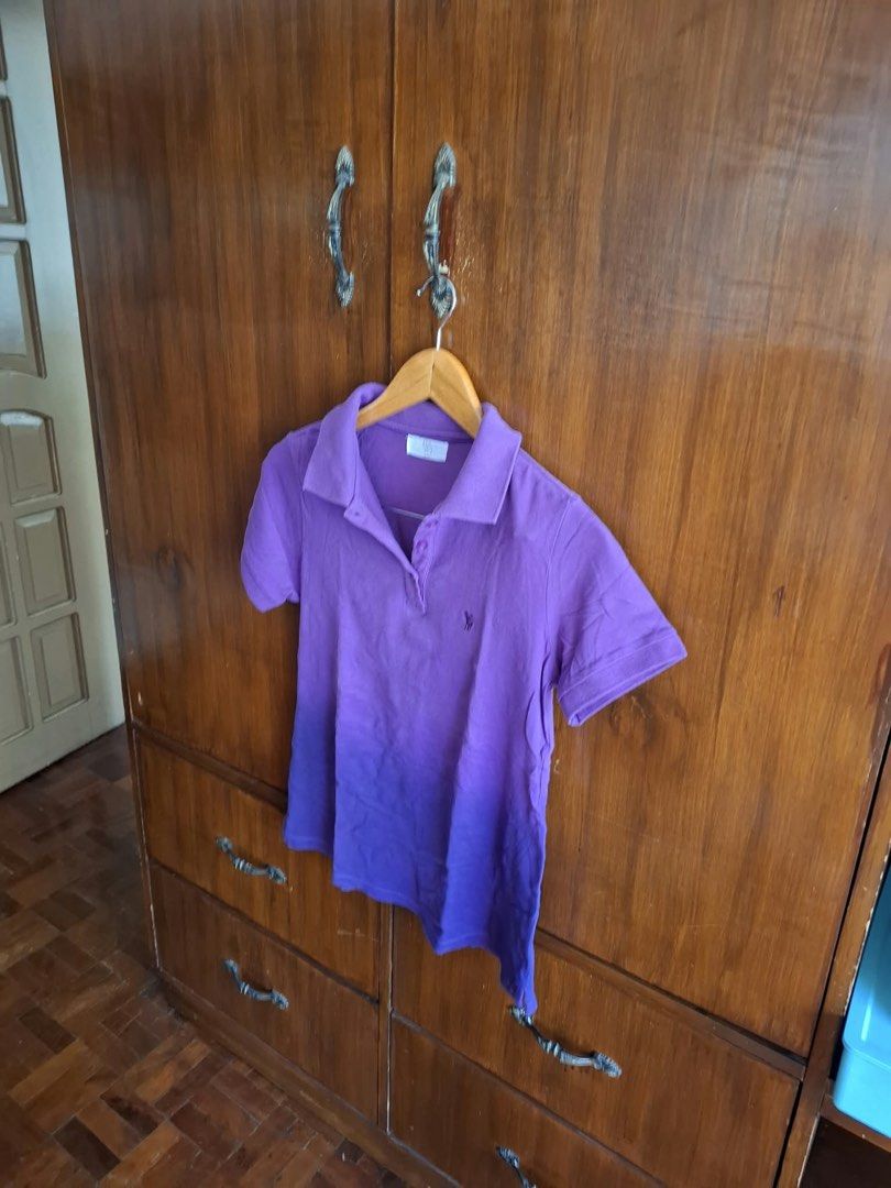 Bayo Purple Polo Shirt (Category: Tshirts & Polo Shirts ) located in Manila. Submitted by bunbun__ (Listing ID 1466414261, Image 2). Description: - Brand: Bayo - Color: Purple - Material: Comfortable cotton blend - Fit: Standard fit - Details: Classic collar, front button placket, short sleeves, ribbed cuffs and collar, small embroidered chest detail - Condition: Excellent, easy to style for casual days.