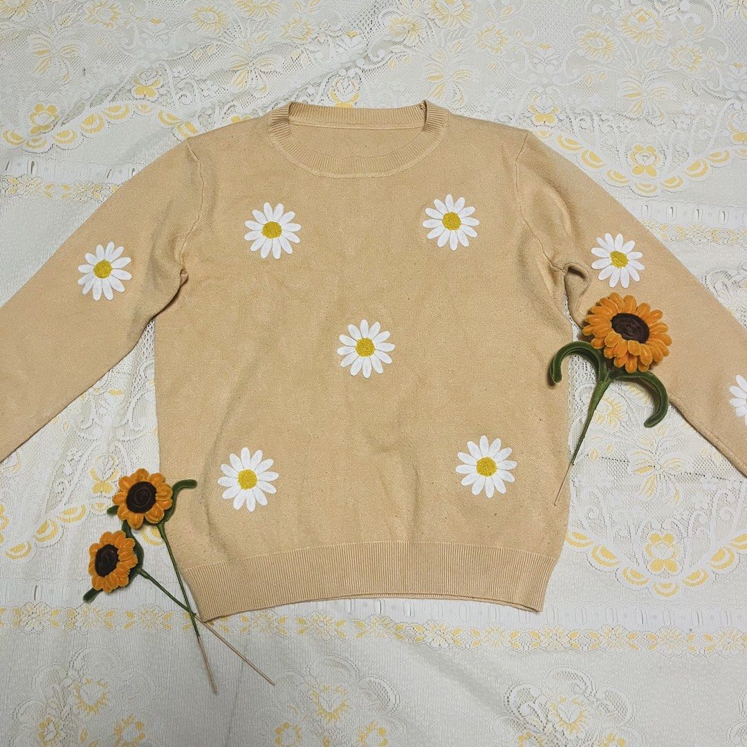 Mustard/ Beige Daisy Knitted Sweater Crewneck Pullover Coquette (Category: Longsleeves) located in Quezon City. Submitted by rie.g (Listing ID 1466481153, Image 1). Description: - Color: Beige with white daisy patches - Material: Soft and comfortable knit - Design: Crewneck with ribbed collar, cuffs, and hem - Fit: Relaxed and cozy - Style: Casual wear, perfect for cooler weather.