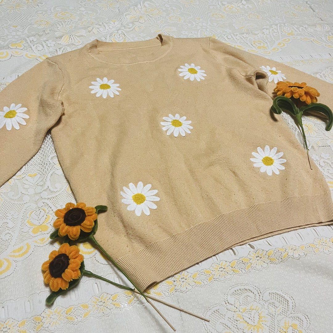 Mustard/ Beige Daisy Knitted Sweater Crewneck Pullover Coquette (Category: Longsleeves) located in Quezon City. Submitted by rie.g (Listing ID 1466481153, Image 2). Description: - Color: Beige with white daisy patches - Material: Soft and comfortable knit - Design: Crewneck with ribbed collar, cuffs, and hem - Fit: Relaxed and cozy - Style: Casual wear, perfect for cooler weather.