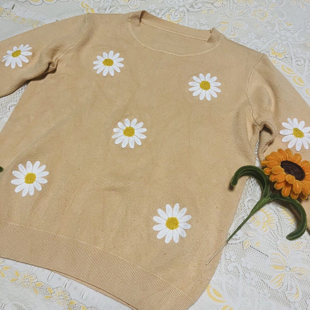 Mustard/ Beige Daisy Knitted Sweater Crewneck Pullover Coquette (Category: Longsleeves) located in Quezon City. Submitted by rie.g (Listing ID 1466481153, Image 3). Description: - Color: Beige with white daisy patches - Material: Soft and comfortable knit - Design: Crewneck with ribbed collar, cuffs, and hem - Fit: Relaxed and cozy - Style: Casual wear, perfect for cooler weather.