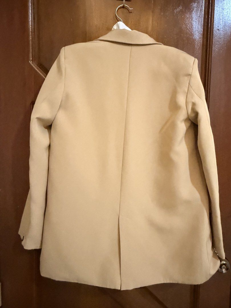 Beige Double Breasted Blazer Jacket (Category: Coats, Jackets and Outerwear) located in Mandaluyong City. Submitted by riz_040521 (Listing ID 1466471008, Image 3). Description: - Color: Versatile beige - Style: Double-breasted button front with notched lapels - Details: Structured shoulders, two front pocket flaps, and back vent hem - Fabric: Clean, solid fabric throughout - Ideal for: Office wear, smart casual outfits, and layering.