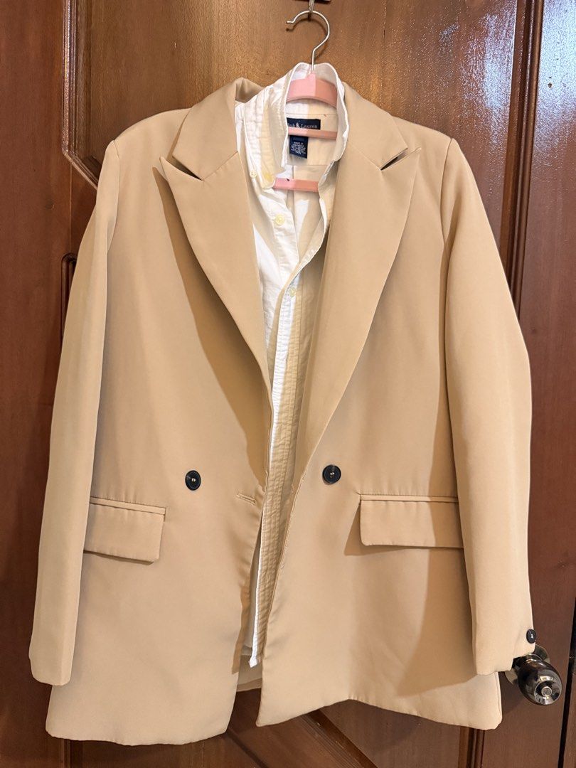 Beige Double Breasted Blazer Jacket (Category: Coats, Jackets and Outerwear) located in Mandaluyong City. Submitted by riz_040521 (Listing ID 1466471008, Image 1). Description: - Color: Versatile beige - Style: Double-breasted button front with notched lapels - Details: Structured shoulders, two front pocket flaps, and back vent hem - Fabric: Clean, solid fabric throughout - Ideal for: Office wear, smart casual outfits, and layering.
