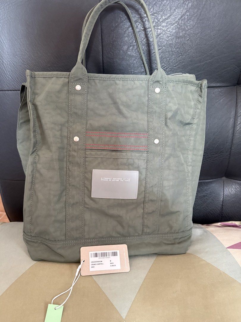 Beyond The Vines Crunch Carryall Sage M (Category: Tote Bags) located in Quezon City. Submitted by brandedthingsforless (Listing ID 1466358848, Image 1). Description: - Brand: Beyond The Vines - Style: Crunch Carryall - Size: Medium - Color: Sage with contrasting red stitch accents - Condition: Brand new with original tags - Features: Secure zippered top closure, roomy interior, durable fabric construction, sturdy double handles, and a convenient