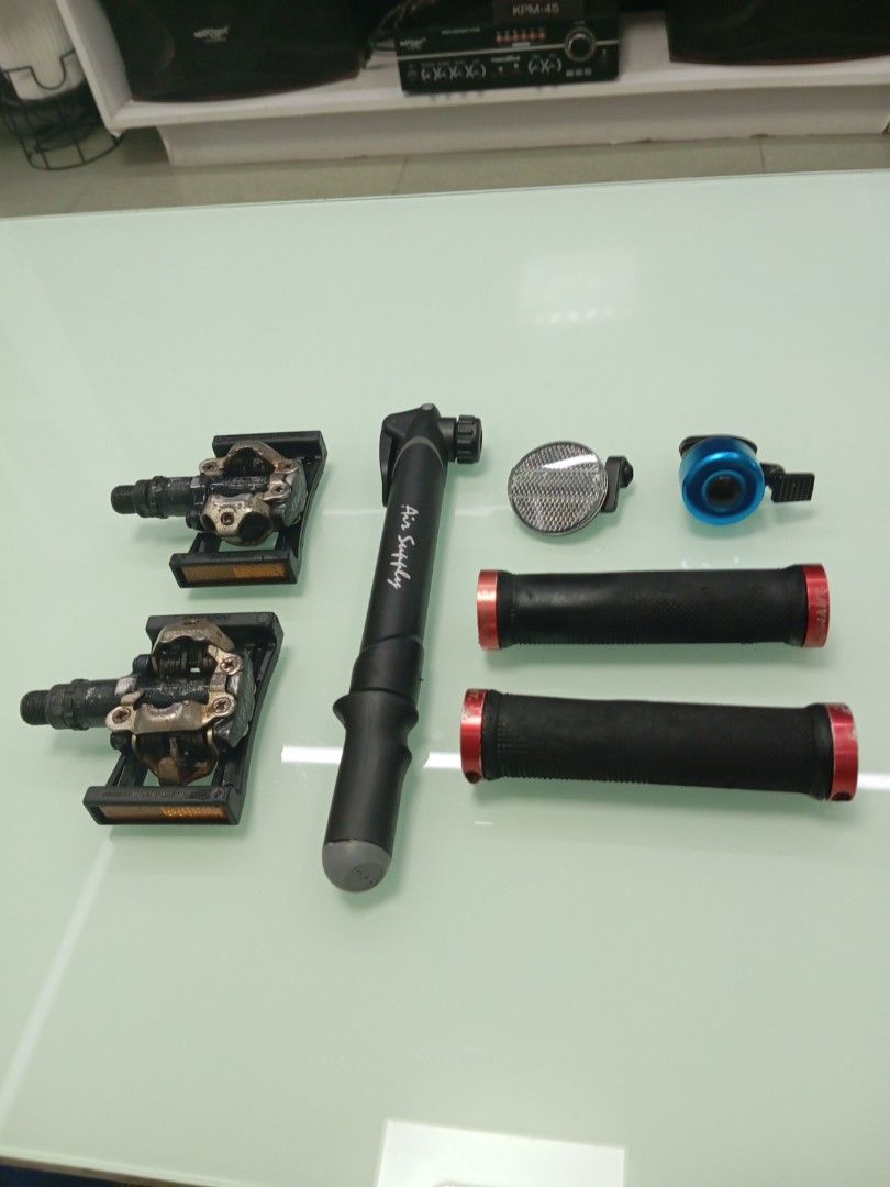 Bicycle accessories bundle pedals pump grips bell reflector, Shimano clipless pedals (Category: Bicycles) located in Caloocan City. Submitted by jonmag31 (Listing ID 1466352288, Image 1). Description: - Shimano Cleat pedals with built-in reflectors - Air Supply mini frame pump - Black handlebar grips with red lock-on rings - Round handlebar reflector - Small blue bicycle bell - Condition: Pulled from an old setup, fully functional with normal wea