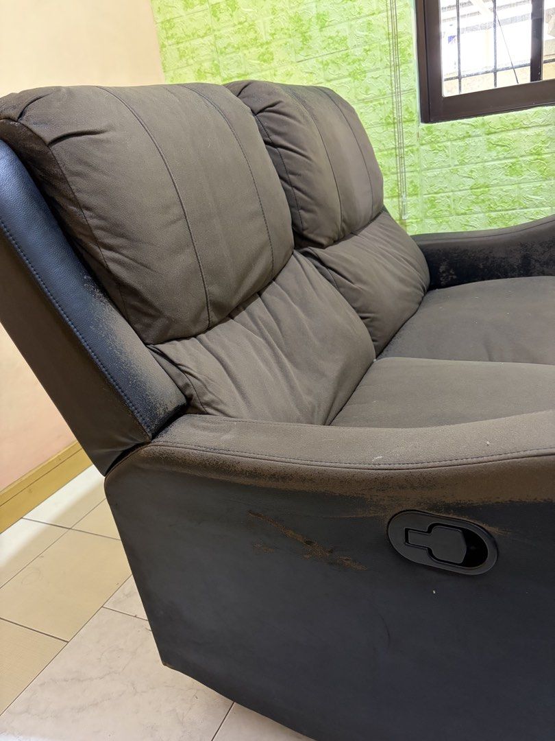Black 2-Seater Recliner Sofa (Category: Sofas) located in Agdangan. Submitted by eun_zurc (Listing ID 1466469768, Image 3). Description: - Type: Two-seater recliner sofa - Color: Black - Mechanism: Manual pull handle for footrests - Comfort: Plush back cushions and armrests - Condition: Sturdy frame and working recline function, but upholstery has heavy wear, flaking, and peeling on arms, top edges, and footrests - Ideal for: Budget buyers, DIY r