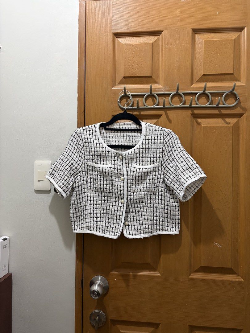 Black and white tweed crop top (Category: Blouses) located in Manila. Submitted by sooprmav (Listing ID 1466548812, Image 1). Description: - Style: Short-sleeve tweed top in a classic black and white check pattern - Design: Elegant round neckline with contrasting white trim and chic pearl-style buttons - Features: Two functional front chest pockets and a trendy cropped length - Fit: Structured fabric for a polished and flattering silhouette - Con