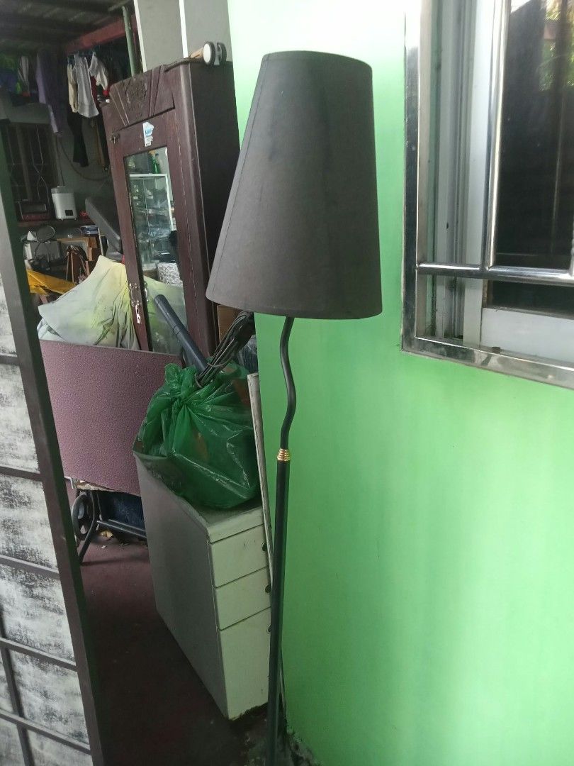 Black floor lamp with tapered shade (Category: Lighting) located in Quezon City. Submitted by madelrivera (Listing ID 1466423976, Image 1). Description: - Sleek standing floor lamp with a slim black metal stem and stylish gold accent - Comes with a chic dark grey/black tapered fabric shade - Perfect space-saving lighting for living room corners or reading areas - 100% working condition, compatible with standard wall outlets - Condition: Good as n