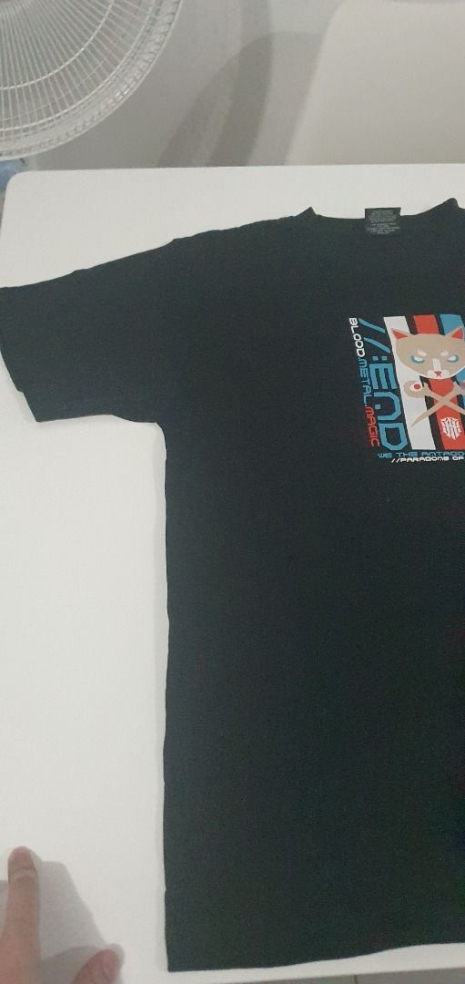 Black Graphic T-Shirt Cat Design (Category: Shirts) located in Quezon City. Submitted by sk8ter13 (Listing ID 1466436195, Image 2). Description: - Color: Black - Design: Front graphic print with a cartoon cat and edgy text ("blood metal magic", "paradise of end") - Fit: Regular fit with short sleeves and standard crew neck - Style: Casual, streetwear, unique graphic apparel - Condition: Brand new / Excellent.