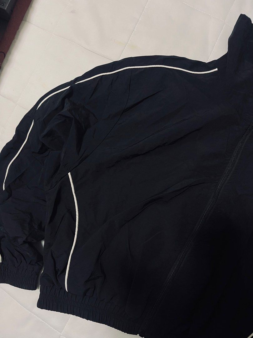 Black Nylon Zip-Up Windbreaker Jacket (Size S) (Category: Activewear) located in Davao. Submitted by curatedcloset.dvo (Listing ID 1466476517, Image 3). Description: • Brand: No Brand but looks and feels exactly like the H&Ms Jacket Windbreaker Nylon • Original Price: ₱800 • Size: Small (S) on tag • Material: 100% Nylon Polyamide Shell / Polyester Lining on tag • Color: Classic Black with White piping accents • Condition: 10/10 excellent conditio