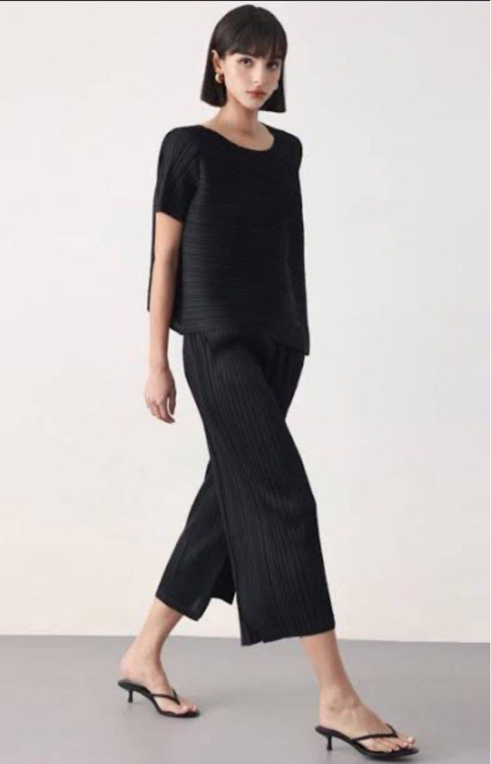 Black Pleated Asymmetrical Top (Category: Blouses) located in Donsol. Submitted by saksthriftavenuebyluckymaria8 (Listing ID 1466356057, Image 1). Description: - Color: Black - Set includes: Short sleeve top with asymmetrical draped hem and round neckline + matching pleated cropped wide-leg pants - Material: Lightweight fabric with all-over fine pleats - Fit: Relaxed fit for maximum comfort - Versatility: Wear together as a set or style separatel
