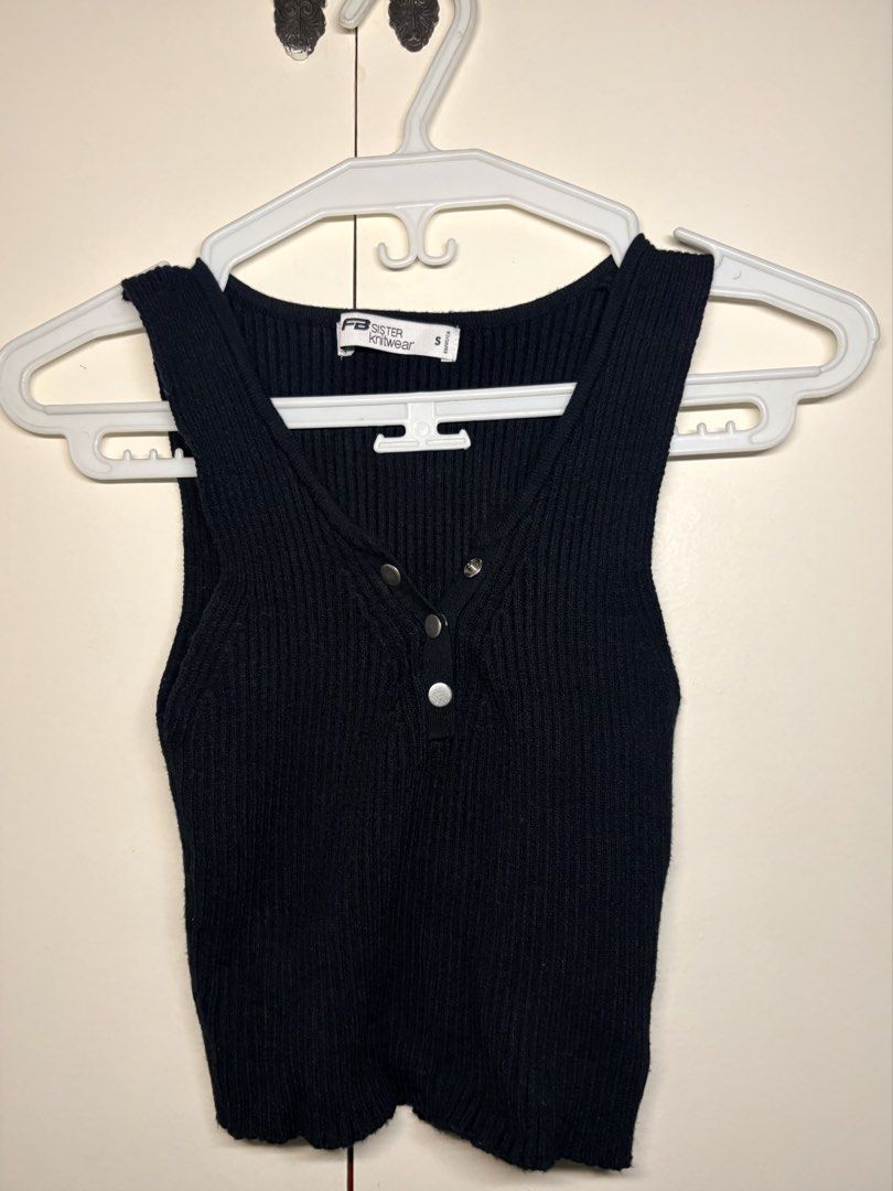 Black Ribbed Button Tank Top (Category: Sleeveless) located in Paranaque City. Submitted by honeykkkk (Listing ID 1466479694, Image 1). Description: • Details: Classic black ribbed knit material, sleeveless design with wide shoulder straps, deep scoop/U-neckline, and front snap-button details. A versatile basic perfect for layering or pairing with high-waisted bottoms. • Condition: Like new — worn once only. • Original Retail Price: PHP 500 – PHP