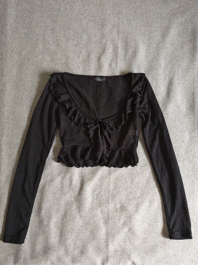 Black Ruffle Cardigan Top (Category: Longsleeves) located in Manila. Submitted by goku_doggo (Listing ID 1466364595, Image 1). Description: - Brand: BMG Boy Meet Girl (Made in Korea) - Style: Black knit cardigan with single button closure and scoop neckline - Details: Adorable frilly ruffle trim along the collar, placket, and hem - Material: Lightweight, slightly sheer knit - Size: Size F (Best fits Small to Medium).