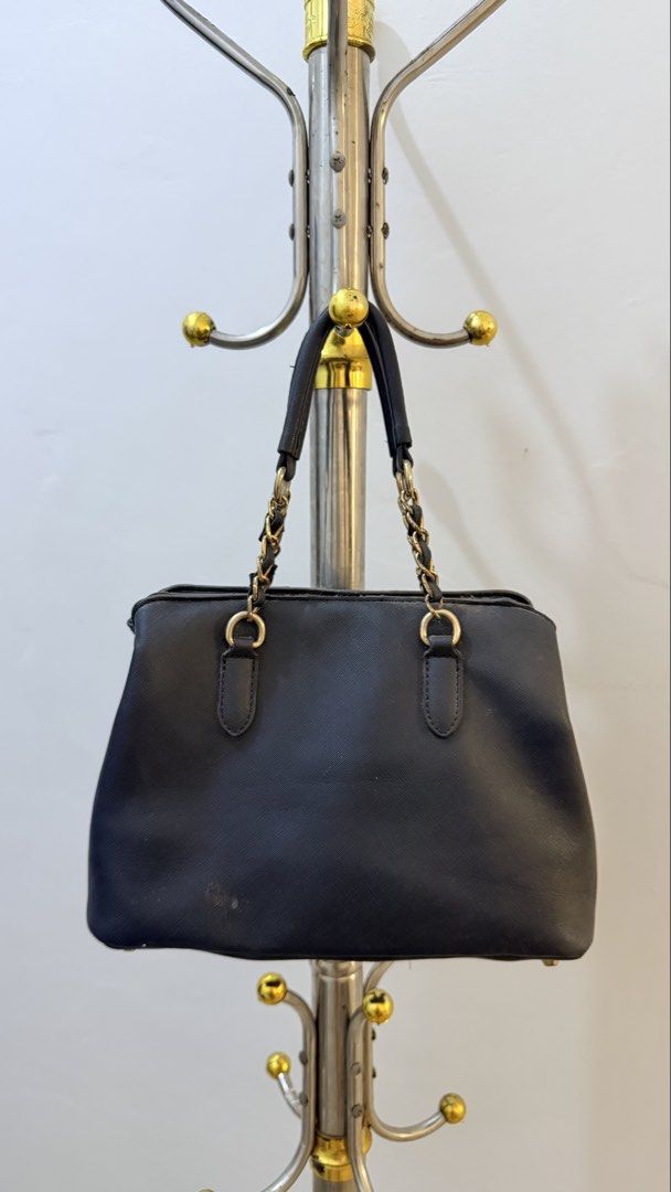 Black structured handbag with chain straps and scarf charm (Category: Shoulder Bags) located in Manila. Submitted by laxamanapa81165 (Listing ID 1466538952, Image 1). Description: - Color & Material: Black textured structured handbag - Straps: Dual handles combining leather-look material and gold-tone chains - Accessories: Includes a detachable black-and-white patterned twilly scarf - Interior/Base: Spacious main compartment with a sturdy base an