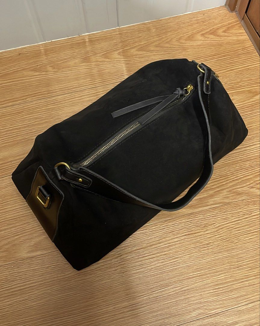 Black Suede Shoulder Bag with Gold Hardware (Category: Shoulder Bags) located in Manila. Submitted by navo.dyfinds (Listing ID 1466348730, Image 3). Description: - Material: Black suede with smooth leather accents - Hardware: Elegant gold-toned hardware - Closure: Top zip closure with double zipper pulls - Strap: Single structured shoulder strap with metal rings - Interior: Roomy compartment with patterned grey fabric lining - Style: Minimalist, 