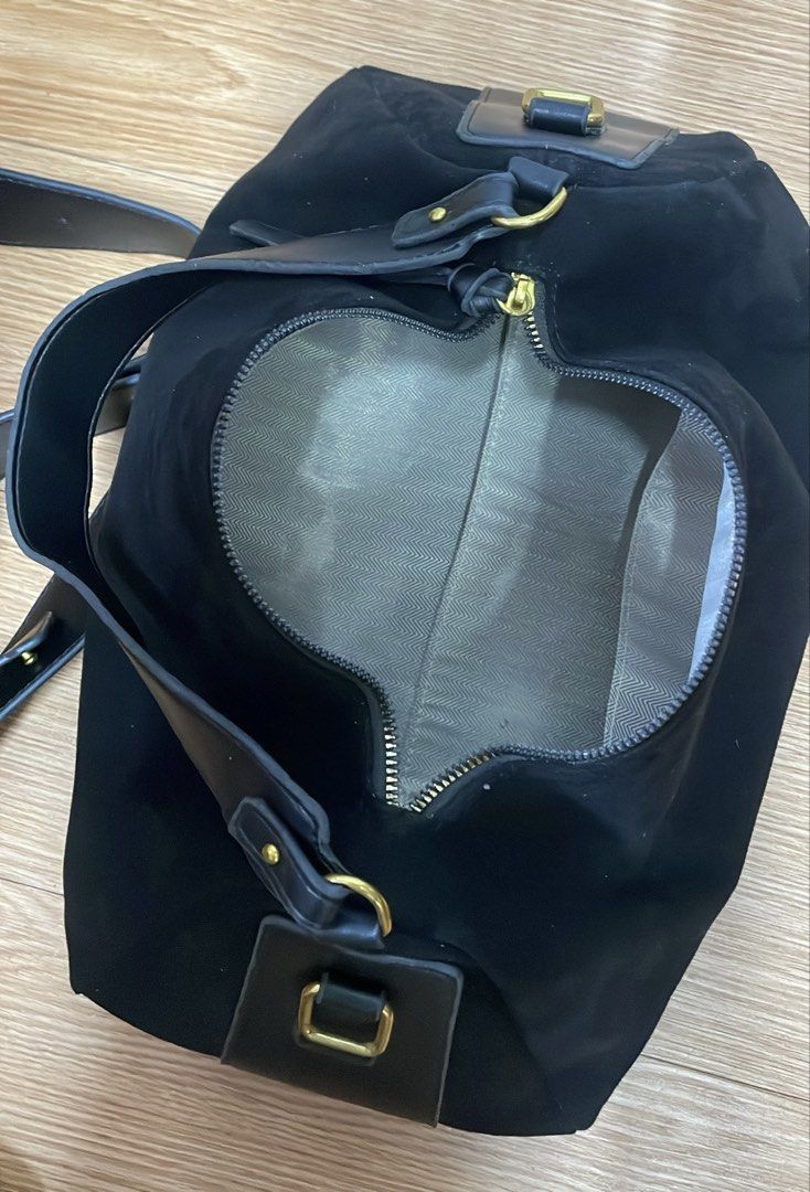 Black Suede Shoulder Bag with Gold Hardware (Category: Shoulder Bags) located in Manila. Submitted by navo.dyfinds (Listing ID 1466348730, Image 2). Description: - Material: Black suede with smooth leather accents - Hardware: Elegant gold-toned hardware - Closure: Top zip closure with double zipper pulls - Strap: Single structured shoulder strap with metal rings - Interior: Roomy compartment with patterned grey fabric lining - Style: Minimalist, 