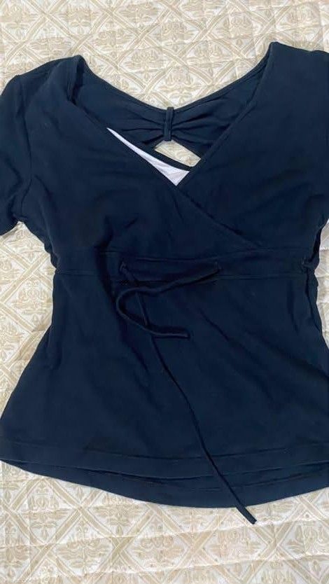 Black Wrap Front Top with Tie Waist (Category: Blouses) located in Pagadian. Submitted by kahtlopez47867 (Listing ID 1466477280, Image 1). Description: - Color: Dark navy / Black - Style: Wrap front with adjustable side tie strings & back cutout detail - Sleeves: Short sleeve - Material: 97% Rayon, 3% Spandex (super soft & stretchy) - Condition: Excellent / Great basic piece - Styling: Easy to pair with denim or skirts - Mode of Payment: GCash, B