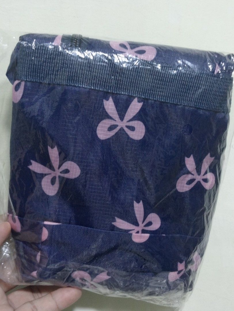 Blue Bow Print Travel Duffle Bag (Category: Activewear) located in Makati City. Submitted by redisell (Listing ID 1466337255, Image 2). Description: - Color & Pattern: Navy blue with an all-over pink bow pattern - Dimensions: 44.5cm x 30cm x 13cm (12cm handle drop) - Features: Front zipped pocket for extra storage and foldable design that packs flat - Condition: Brand new, still sealed in original plastic packaging.