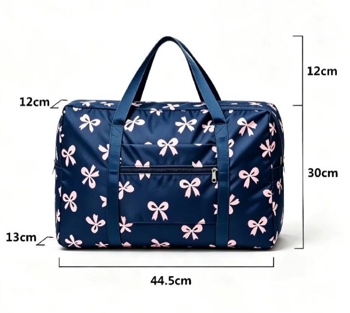 Blue Bow Print Travel Duffle Bag (Category: Activewear) located in Makati City. Submitted by redisell (Listing ID 1466337255, Image 1). Description: - Color & Pattern: Navy blue with an all-over pink bow pattern - Dimensions: 44.5cm x 30cm x 13cm (12cm handle drop) - Features: Front zipped pocket for extra storage and foldable design that packs flat - Condition: Brand new, still sealed in original plastic packaging.