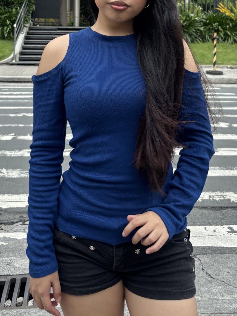 Blue cold shoulder long sleeve ribbed top (Category: Longsleeves) located in Quezon City. Submitted by yanabanaenae (Listing ID 1466499447, Image 1). Description: - Color: Royal blue - Design: Ribbed texture with trendy cold shoulder cutouts - Fit: Fitted, long sleeves, and stretchy for all-day comfort - Styling: Perfect to pair with high-waisted shorts or jeans - Condition: Excellent/Brand New (ready to wear).