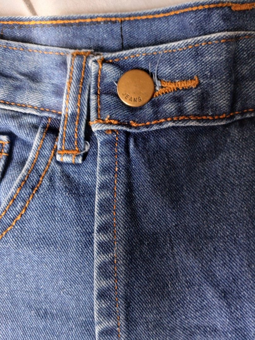 Blue Denim Skort Asymmetrical Wrap Front Shorts (Category: Skirts) located in Manila. Submitted by relaxlang (Listing ID 1466396076, Image 3). Description: - Size 28-29 - Dark indigo wash blue denim skort - Trendy asymmetrical wrap-around front panel - Skirt appearance on the outside with practical shorts underneath - Flattering high-waisted cut with a single metallic button closure - Stylish contrast orange stitching details - Functional front p