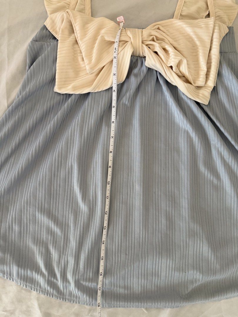 Blue Ribbed Top with Cream Ruffle Straps and Bow (Category: Sleeveless) located in Santa Rosa. Submitted by itskllycstll (Listing ID 1466402870, Image 3). Description: - Color: Light blue with cream accents - Material: Stretchy ribbed fabric for a comfortable fit - Design: Sweet cream ruffles on shoulder straps and a large front bow - Length: Approx. 18 inches from top of shoulder - Style: Easy slip-on piece, perfect and comfy for warm weather 📍