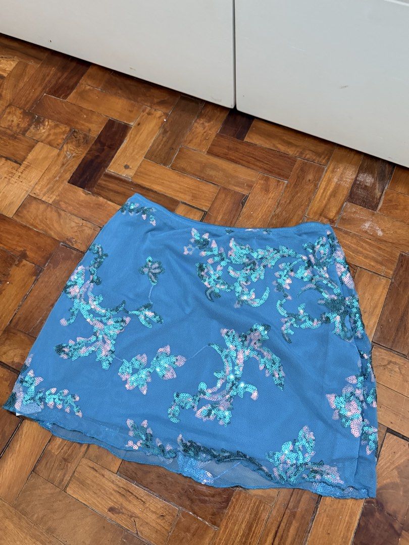 Blue Sequin Mesh Mini Skirt Size XS (Category: Skirts) located in Manila. Submitted by wearagainfinds (Listing ID 1466411206, Image 1). Description: - USES ONCE! - Style: Fun party mini skirt - Design: Blue mesh with teal and pink sequin floral patterns - Size: can fit to s-m - Features: Fully lined underneath, side zipper closure - Condition: Brand new / Excellent.
