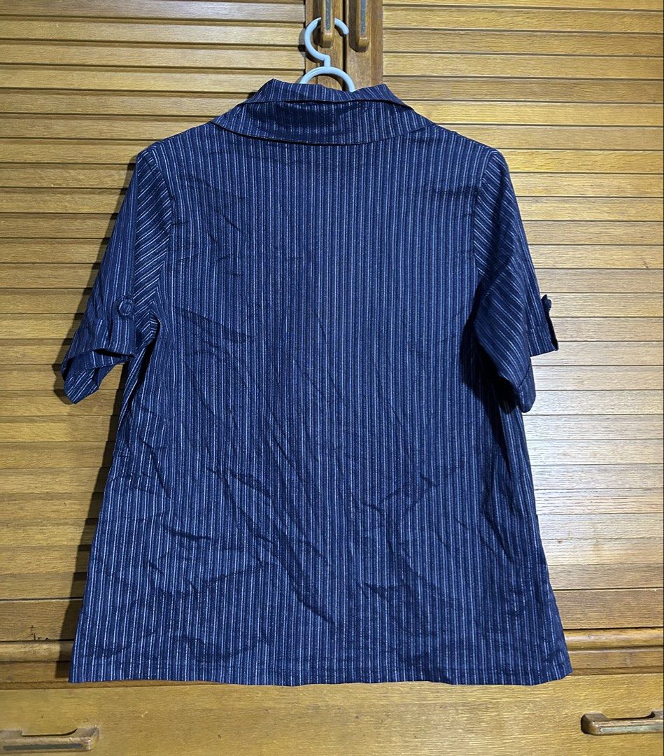 Blue striped button-up short sleeve blouse with pockets (Category: Blouses) located in Manila. Submitted by quincy.67 (Listing ID 1466449421, Image 2). Description: - Color/Pattern: Navy blue with thin white vertical stripes - Design: Short sleeves, pointed collar, and partial button front.