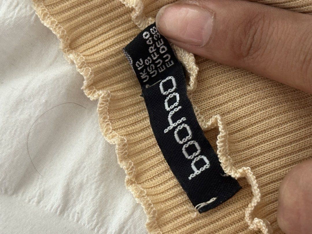 Boohoo Ribbed Off-Shoulder Crop Top (Category: Sleeveless) located in Mandaluyong City. Submitted by youarecutejeans (Listing ID 1466442366, Image 2). Description: - Brand: Boohoo - Size: UK 12 / US 8 / EUR 40 - Color: Classic Beige - Style: Off-shoulder ribbed knit top with short sleeves - Details: Trendy lettuce hem on neckline and cuffs - Material: Soft and stretchy fabric - Condition: Great basic piece for everyday casual wear.