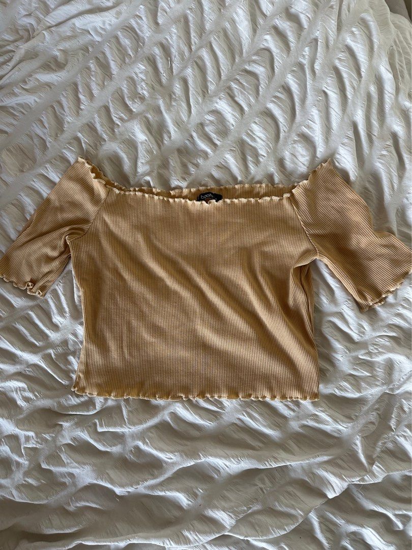 Boohoo Ribbed Off-Shoulder Crop Top (Category: Sleeveless) located in Mandaluyong City. Submitted by youarecutejeans (Listing ID 1466442366, Image 1). Description: - Brand: Boohoo - Size: UK 12 / US 8 / EUR 40 - Color: Classic Beige - Style: Off-shoulder ribbed knit top with short sleeves - Details: Trendy lettuce hem on neckline and cuffs - Material: Soft and stretchy fabric - Condition: Great basic piece for everyday casual wear.