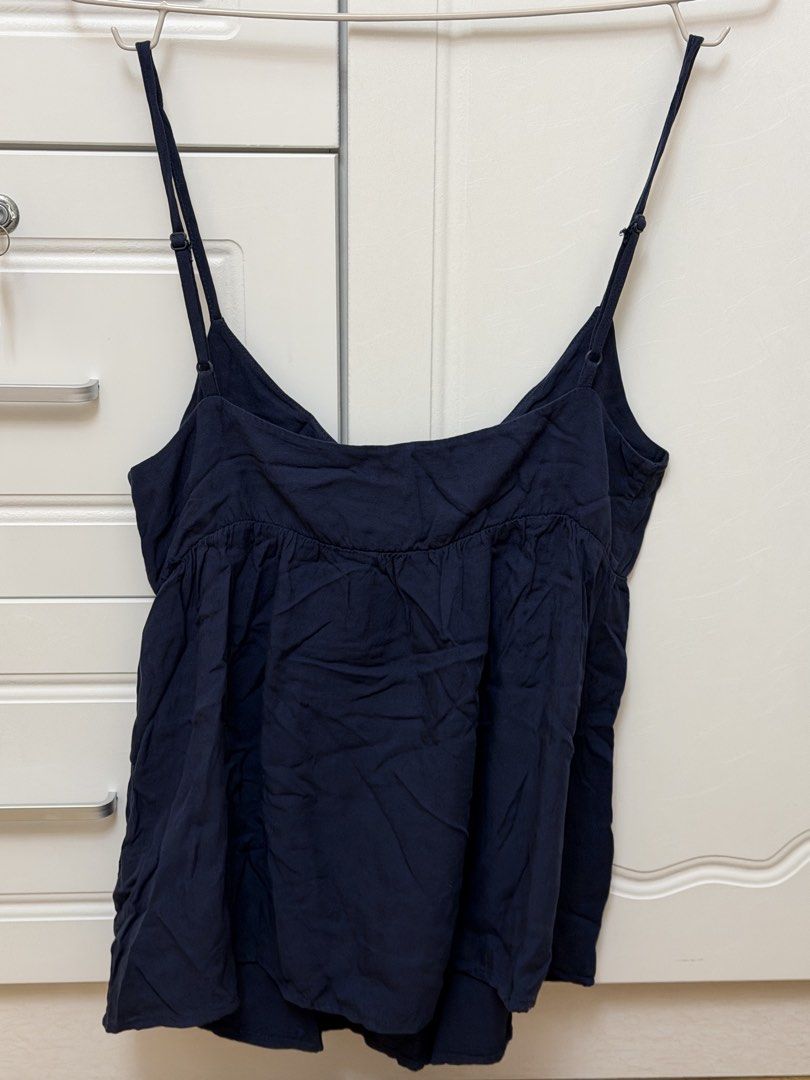 Brandy Melville Navy Blue Edith Tank (Category: Sleeveless) located in Pasay City. Submitted by erickaolalu (Listing ID 1466414914, Image 2). Description: 🏷️ bought from the US for ₱2,150 (Free size XS - S) too small for me 🥹 - Brand: Brandy Melville - Style: Edith Tank Top - Color: Dark Navy Blue - Details: Adjustable spaghetti straps, crossover v-neckline, gathered empire waist, lightweight flowy fit - Condition: Worn once just to fit. - Styl