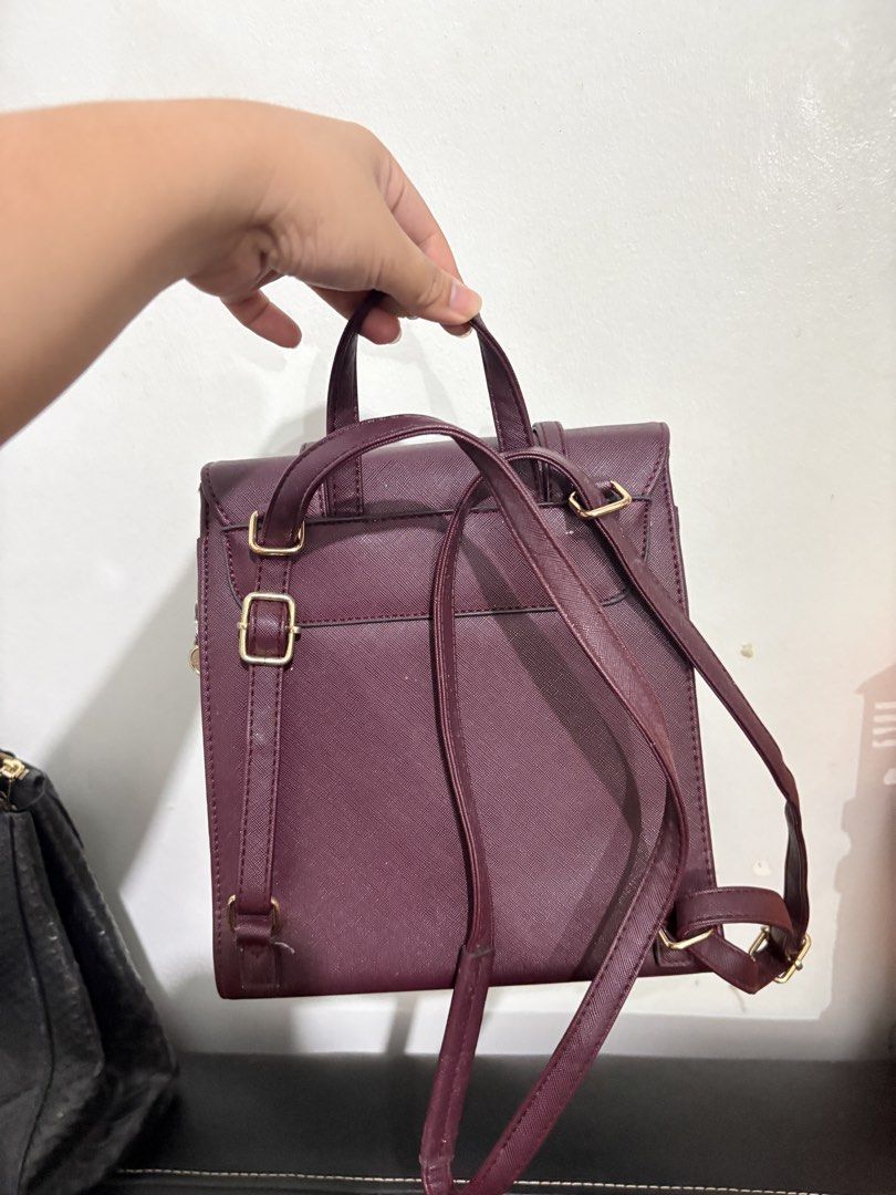 British Polo Maroon Faux Leather Backpack (Category: Backpacks) located in Makati City. Submitted by prlyrose (Listing ID 1466367268, Image 3). Description: - Brand: British Polo - Color/Material: Maroon faux leather with gold-tone hardware - Design: Structured boxy shape with front flap and magnetic closure - Interior: Branded fabric lining with multiple compartments and a zippered middle pocket - Carry options: Adjustable back straps and top ha