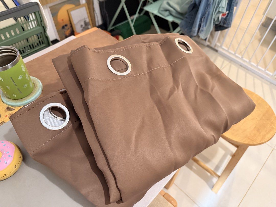 Brown Blackout Curtains Panel Set (Category: Curtains & Blinds) located in Mandaluyong City. Submitted by ohayouclub (Listing ID 1466379995, Image 1). Description: - Color: Solid brown (neutral earth tone) - Material: Smooth, clean fabric - Hardware: Silver metal grommet rings on top - Fit: Easily fits standard curtain rods .