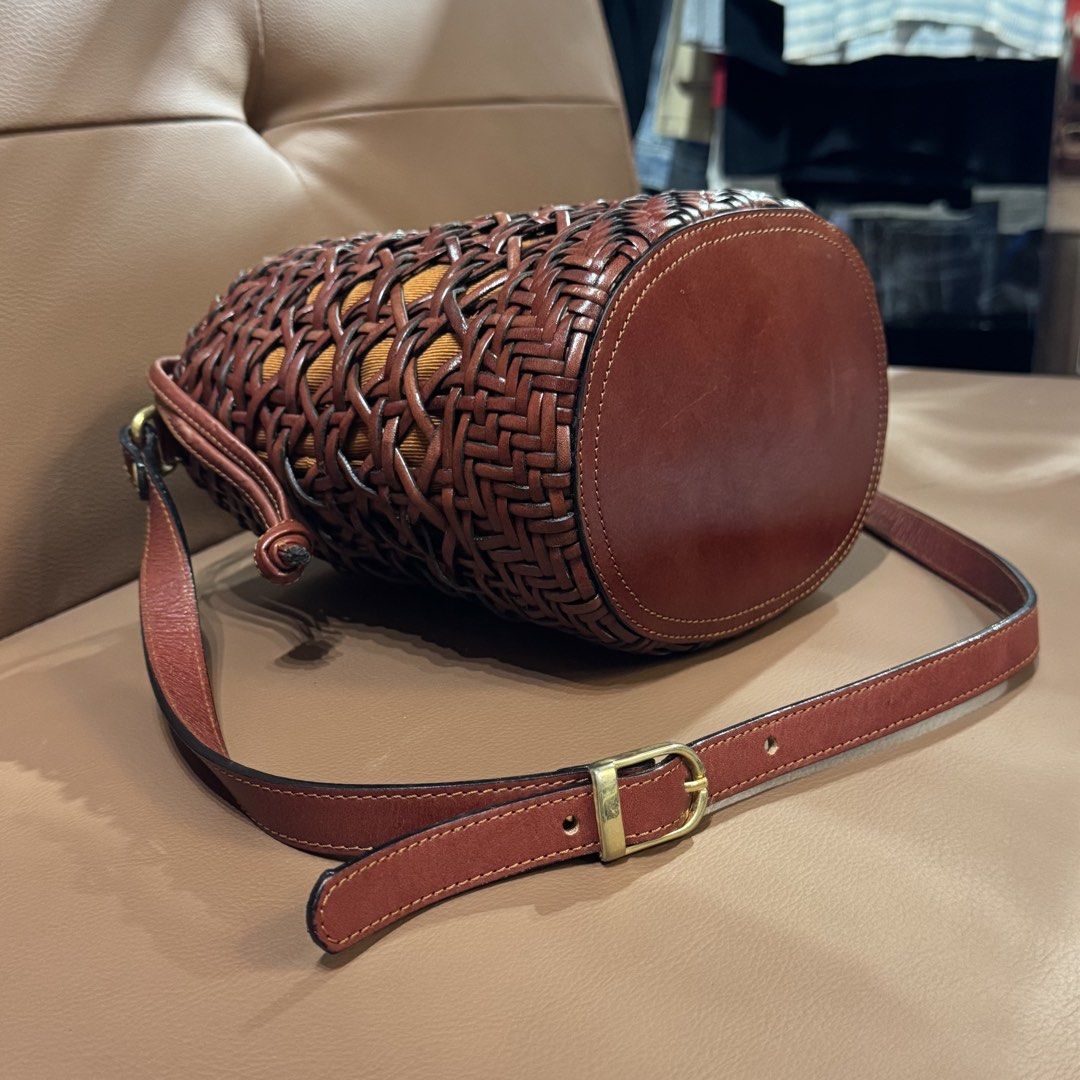 Brown Woven Leather Bucket Bag With Drawstring Insert (Category: Shoulder Bags) located in Rizal. Submitted by houseofbell (Listing ID 1466495141, Image 3). Description: - Style: Brown leather bucket bag with woven outer cage - Closure: Mustard yellow inner drawstring pouch for security - Strap: Adjustable leather shoulder strap with brass buckle - Base: Flat leather bottom structure - Condition: Good structure overall like new condition -Made by