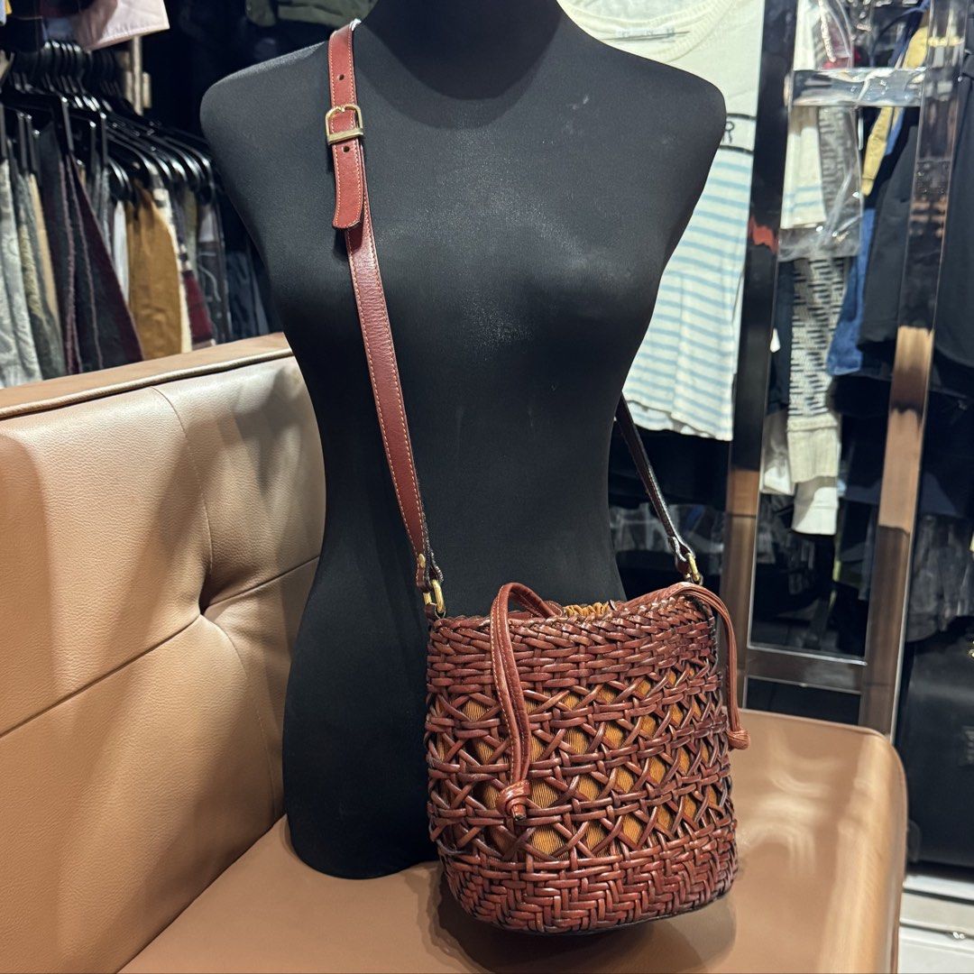 Brown Woven Leather Bucket Bag With Drawstring Insert (Category: Shoulder Bags) located in Rizal. Submitted by houseofbell (Listing ID 1466495141, Image 2). Description: - Style: Brown leather bucket bag with woven outer cage - Closure: Mustard yellow inner drawstring pouch for security - Strap: Adjustable leather shoulder strap with brass buckle - Base: Flat leather bottom structure - Condition: Good structure overall like new condition -Made by