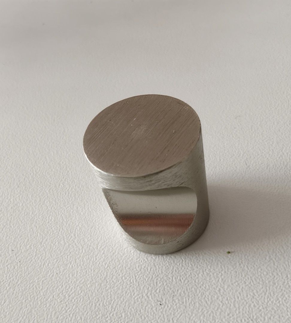 Brushed Nickel Cabinet Knobs (Category: Shelves, Cabinets & Racks) located in Singapore. Submitted by eazy_pz (Listing ID 1466384528, Image 2). Description: - Door knob - Brushed silver metal finish with modern industrial look - Unique scooped front design for a comfortable grip - Solid metal construction with a heavy, premium feel - Suitable for cabinets, drawers, or wardrobe doors - Includes matching mounting screws - Clean overall condition - 