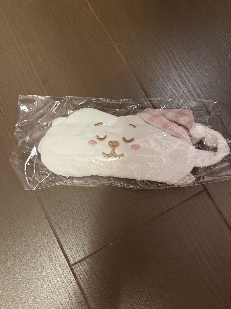 BT21 RJ Sleep Mask Eye Mask (Category: K-Wave Merchandise) located in Marikina City. Submitted by culose (Listing ID 1466491826, Image 1). Description: - Character: RJ from BT21 - Material: Soft white plush fabric with embroidered sleepy face - Design: Features an attached pink and white checkered nightcap - Fit: Comfortable elastic strap at the back - Condition: Brand new, unopened, and sealed in original plastic packaging.