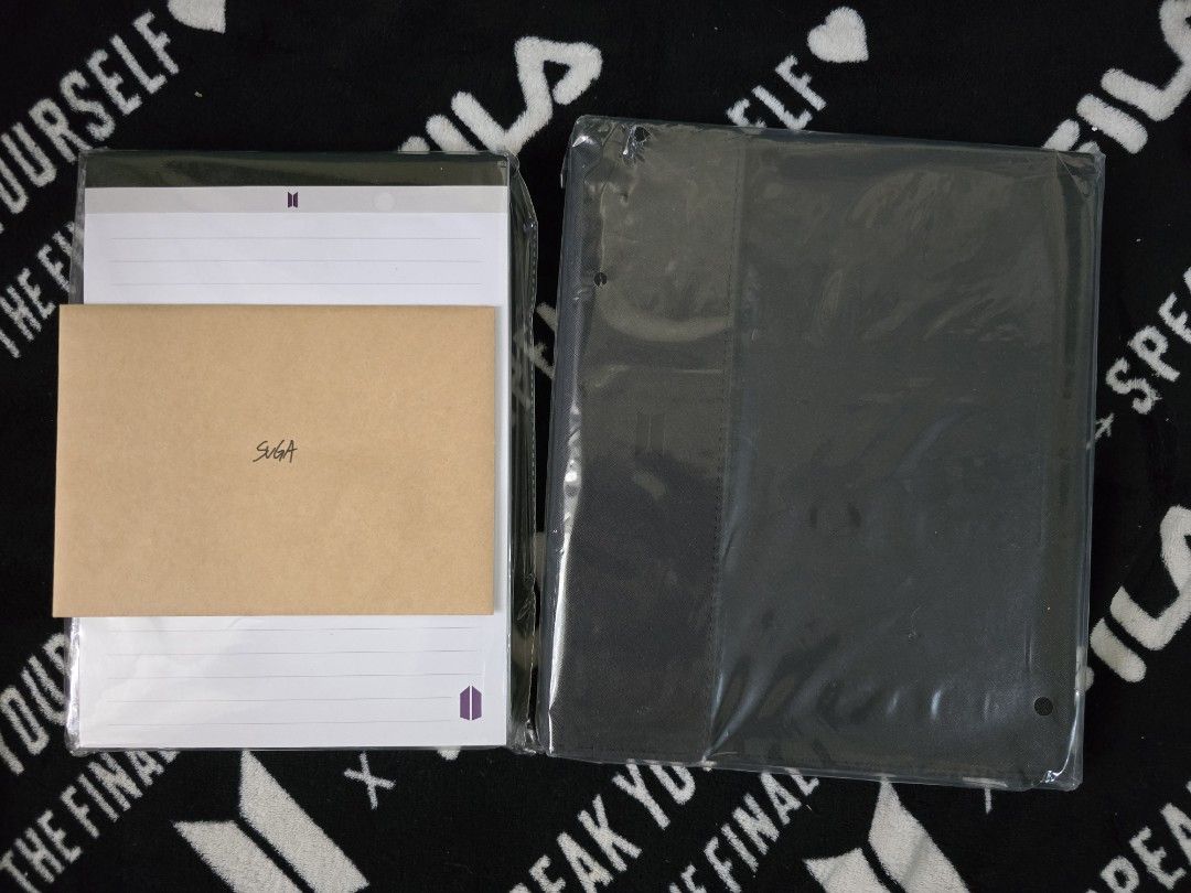 BTS Suga Note Pad and Black Binder Set (Category: K-Wave Merchandise) located in Davao. Submitted by aikaerika (Listing ID 1466525241, Image 1). Description: - 100% Official BTS merchandise set - Includes: Lined notepad with purple BTS logo, brown envelope featuring Suga's handwritten signature, and a dark black binder - Condition: Brand new, unopened, and unused - Packaging: Still sealed in original clear plastic - Perfect addition to your BTS c