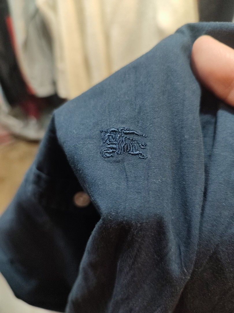 Burberry Brit Navy Blue Button Down Shirt (Category: Tshirts & Polo Shirts ) located in Manila. Submitted by momofunodos (Listing ID 1460198682, Image 3). Description: ALL ITEMS ARE PRE-LOVED ✅Bale source. ✅Ukay thrifted. ✅Manage your expectations these are ukay.( dont expect crispy as new) ✅ Colors may different in person due to camera lens and lights. ✅ There's a sign of usage in every item ✅ Small stain washable stain are normal in ukay we do 