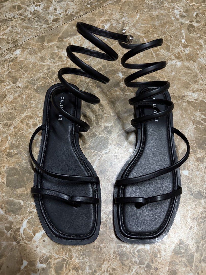 Calliope Black Strap Sandals (Category: Flats & Sandals) located in Bacoor. Submitted by jblns (Listing ID 1466441217, Image 1). Description: - Brand: Calliope - Color: Black - Size: 40 - Style: Flat sandals with trendy square toes and slender straps - Details: Long straps that wrap around the legs Brand new, never used.