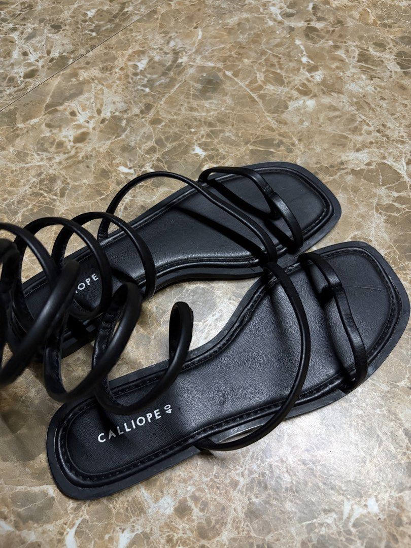 Calliope Black Strap Sandals (Category: Flats & Sandals) located in Bacoor. Submitted by jblns (Listing ID 1466441217, Image 3). Description: - Brand: Calliope - Color: Black - Size: 40 - Style: Flat sandals with trendy square toes and slender straps - Details: Long straps that wrap around the legs Brand new, never used.