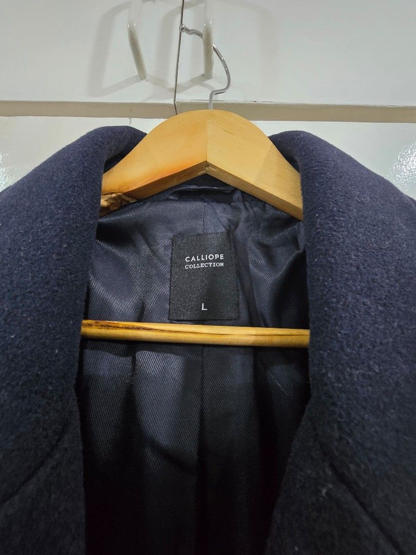 Calliope Navy Blue Wool Blend Peacoat Jacket Size L (Category: Coats, Jackets and Outerwear) located in Paranaque City. Submitted by poandamum (Listing ID 1466352687, Image 3). Description: - Brand/Model: Calliope dark navy blue peacoat - Size: L - Closure & Collar: Double-breasted button closure with notched lapel - Pockets: Two front welt pockets - Material & Interior: Clean wool blend with structured shoulders and fully lined interior - Style/
